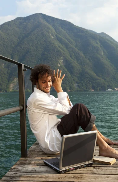 Young man on the dock of Lake — Stock Photo, Image