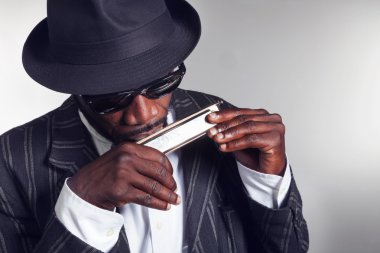 Musician plays the harmonica clipart