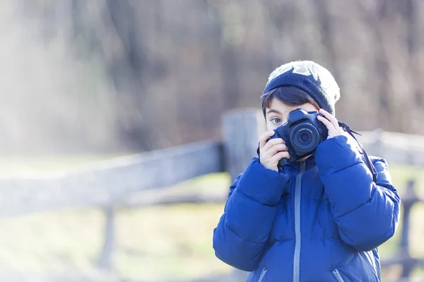 Boy plays with vintage camera — Stock Photo, Image