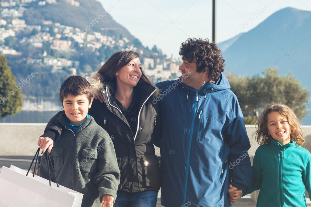 Happy family walking outdoors in city