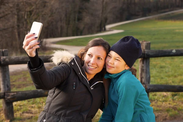 Woman and child shooting selfie — Stock Photo, Image