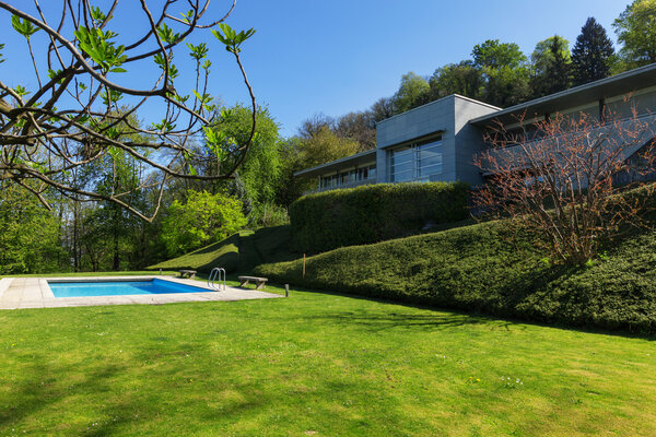 Outside of modern house in summer, swimming pool