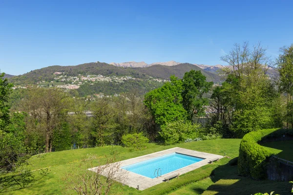 Outside of modern house in summer, swimming pool