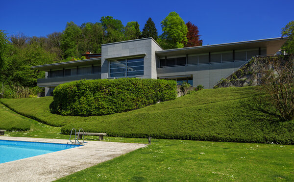 Outside of modern house in summer, swimming pool