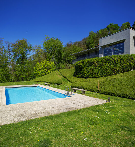 Outside of modern house in summer, swimming pool