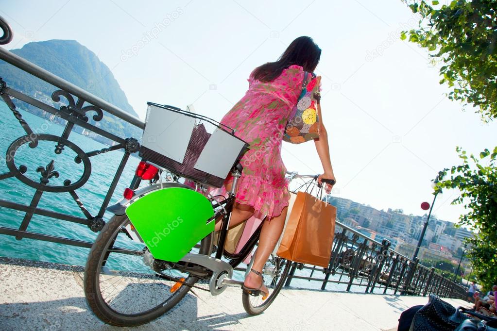 Girl with bike at the lake