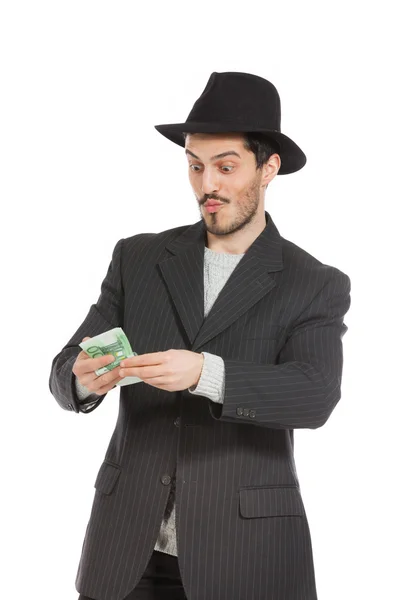 Человек в шляпе и с деньгами — стоковое фото