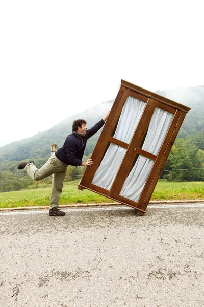 Hombre se mueve armario, está haciendo un movimiento — Foto de Stock