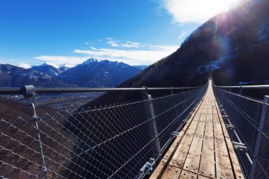 Mountain landscape with suspension bridge clipart