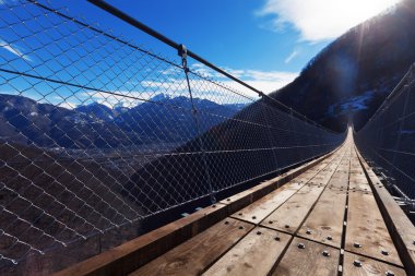 Mountain landscape with suspension bridge clipart