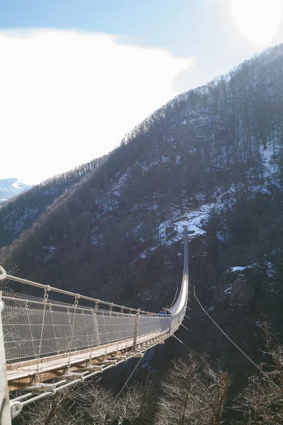 Mountain landscape with suspension bridge — Stock Photo, Image