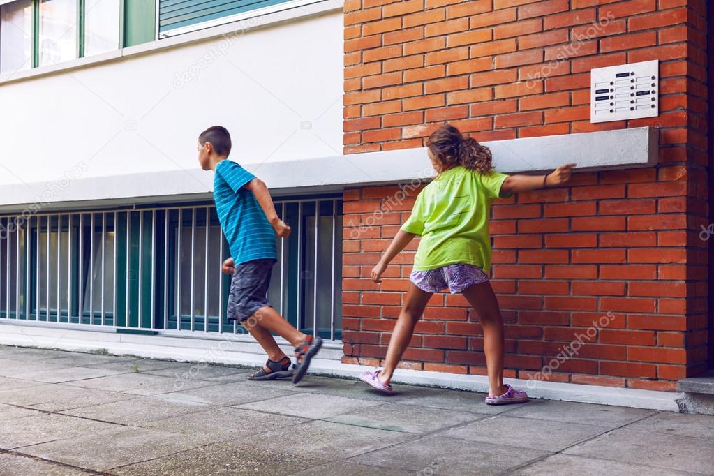 Children ring the bell and run away — Stock Photo © Zveiger 83691392