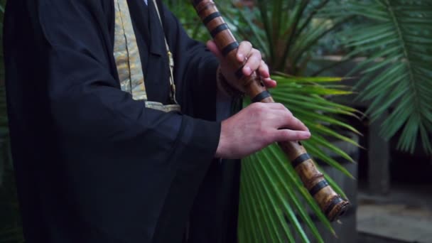 Japanese musician plays on flute — Stock Video