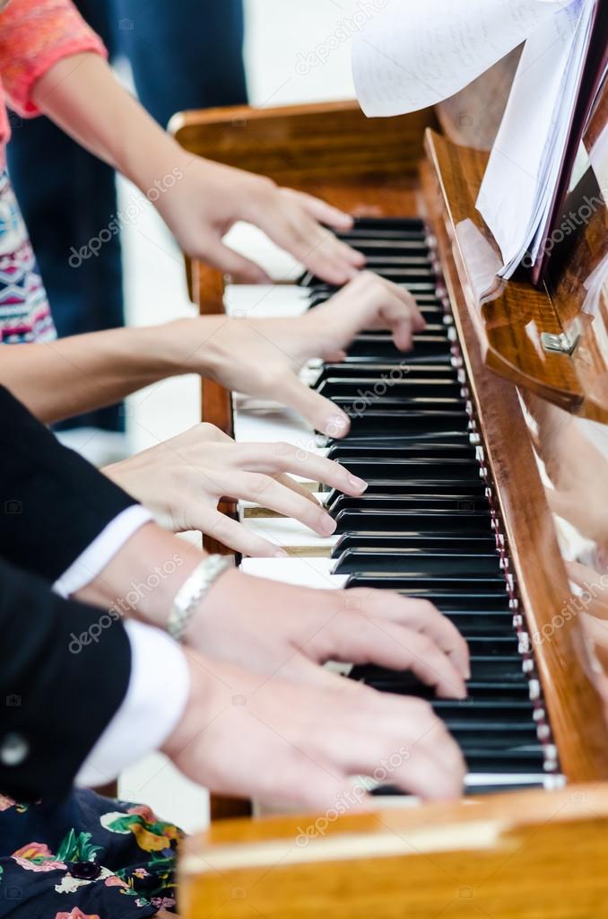 Few people playing piano together