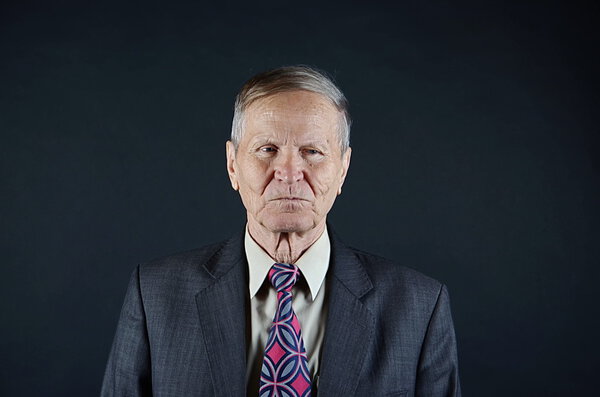 portrait of a business man isolated on black background, studio shot