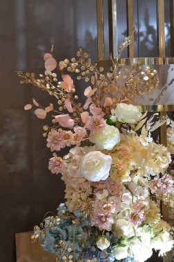 Close-up of a composition of white flowers for a wedding table decoration of the newlyweds