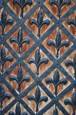 Metal design floral texture.Ancient door background with metal decorative elements. clipart