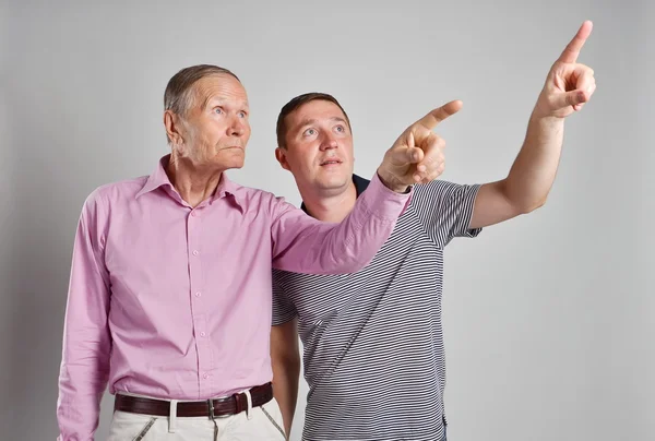 Two men pointing at something — Stock Photo, Image