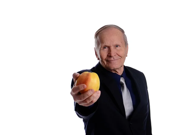 Ο άνθρωπος των επιχειρήσεων κρατώντας ένα μεγάλο κίτρινο μήλο στο χέρι — Φωτογραφία Αρχείου