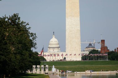 Washington Anıtı 'nın ve Washington DC' deki National Mall 'da bayrakları ve insanları olan ABD Kongre Binası' nın manzarası. g.