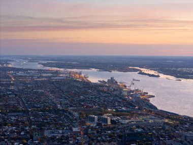 Gün batımında Montreal şehri ve Saint Lawrence Nehri 'nin hava manzarası. Köprüler, gökyüzü ve gökyüzü renklidir. g.