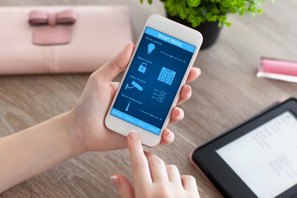 Female hands holding phone with app smart home on screen — Stock Photo, Image