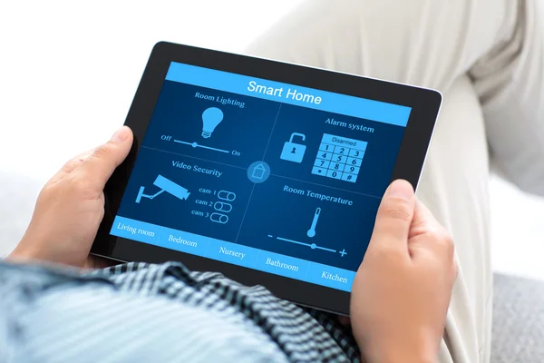 Man holding tablet computer with smart home on the screen — Stock Photo, Image