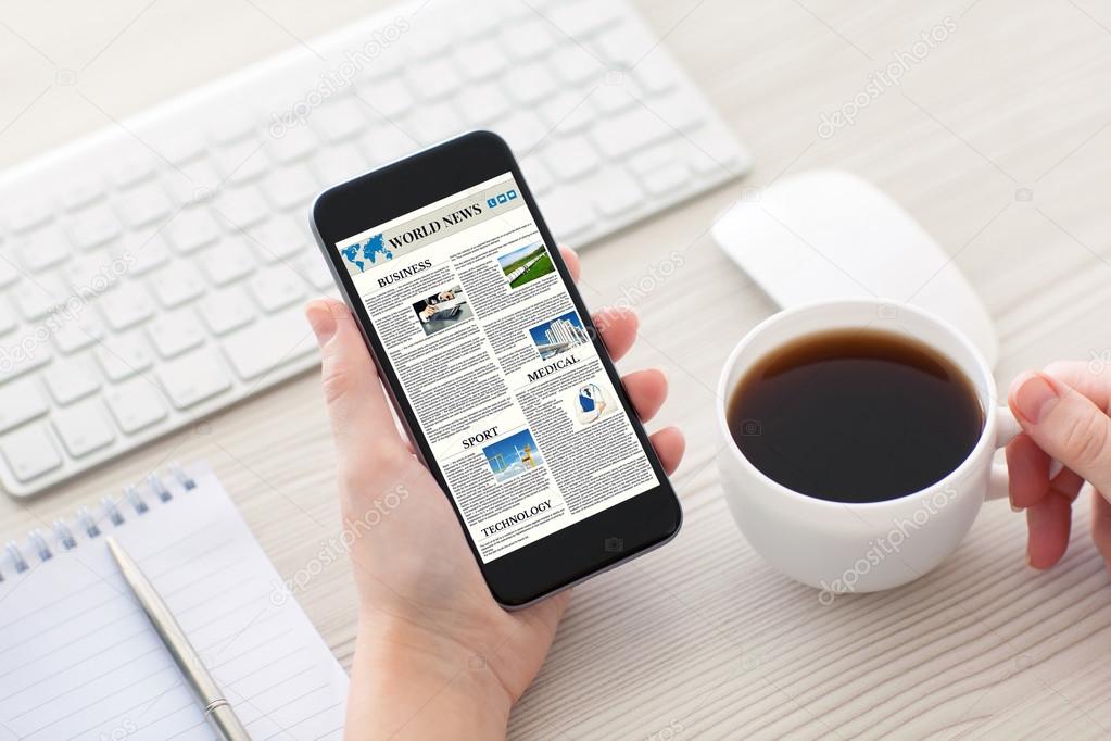 Women hands holding phone with world news site on screen 