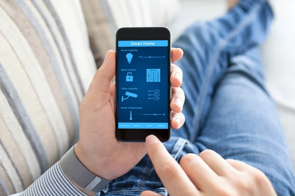 Man holding phone with smart home on screen — Stock Photo, Image