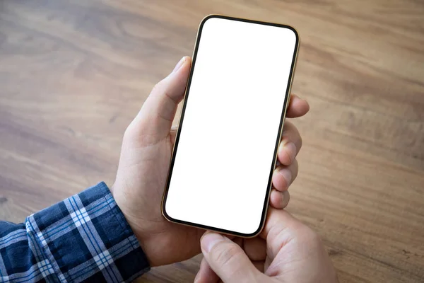 male hands holding golden phone with isolated screen over wooden table