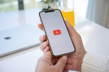 Alanya, Türkiye - 30 Mart 2021: Apple iPhone 12 Pro Max Gold uygulamasını elinde tutan adam ekranda canlı yayın medyası ve video sağlıyor.