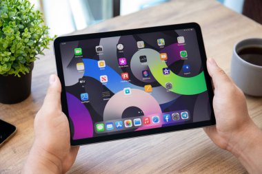 Alanya, Türkiye - 7 Temmuz 2021: İnsan eli iPad Air IOS 14 ile ana ekranda donanım. iPad Apple tarafından yaratıldı ve geliştirildi.