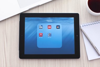 popüler haber app üstünde belgili tanımlık perde ile iPad olan tablo
