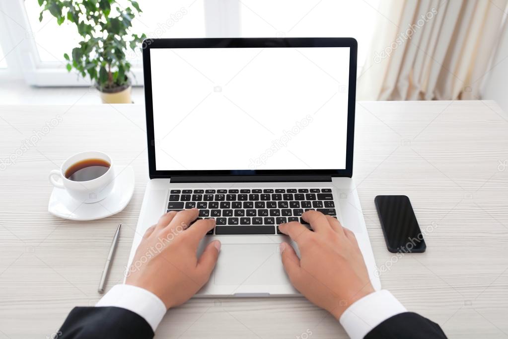 businessman sitting behind a laptop with isolated screen
