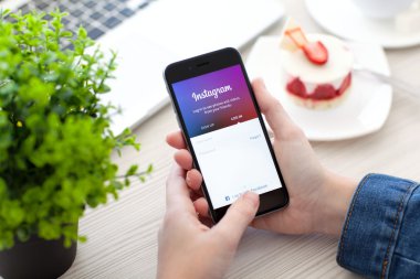 Alushta - 28 Ekim 2014: Ekranda sosyal ağ servisi Instagram ile iPhone 6 Space Gray 'i tutan kadın. iPhone 6 Apple Inc. tarafından oluşturuldu ve geliştirildi
