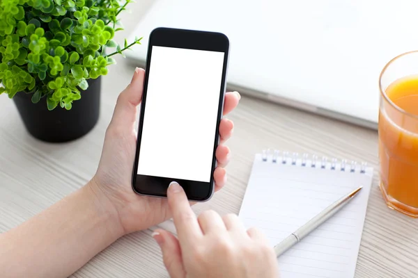 Women hand holding phone with isolated screen above the desk — Stock Photo, Image