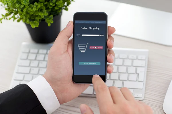 Businessman holding phone with app online on the screen — Stock Photo, Image