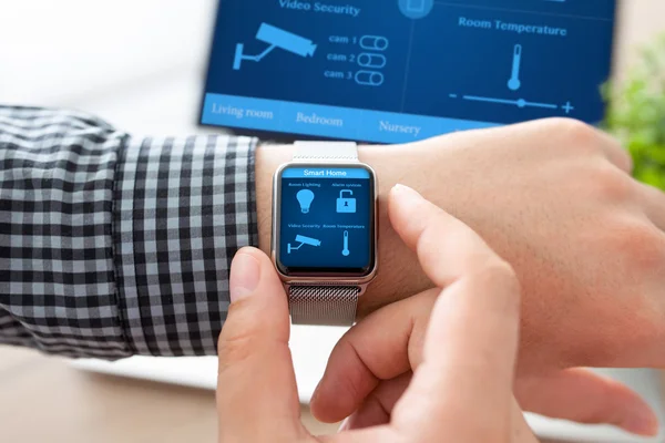 Man hand in watch with smart home and computer — Stock Photo, Image