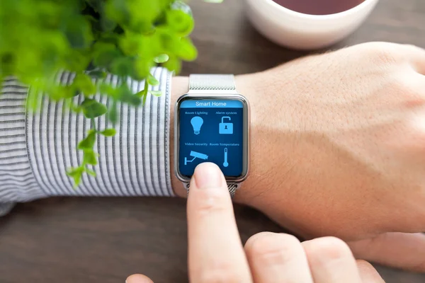 Man hands in watch with program smart home on screen — Stock Photo, Image