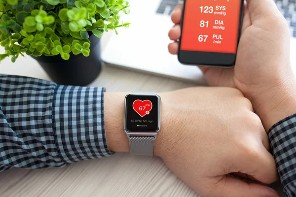 Man händerna med klocka och telefon med app hälsa — Stockfoto