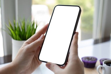 Kafe ofisinde bir fincan kahveyle izole bir ekranı olan bir kadının el ele tutuşması.