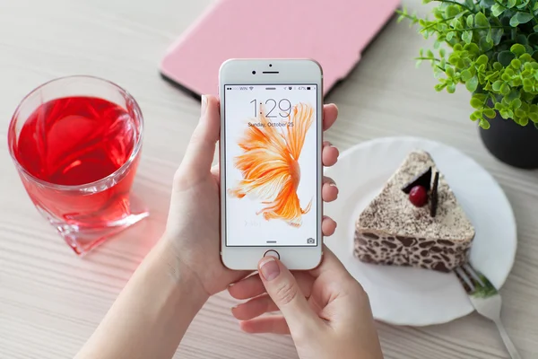 Woman unlock phone iPhone 6S Rose Gold over the table — Stock Photo, Image