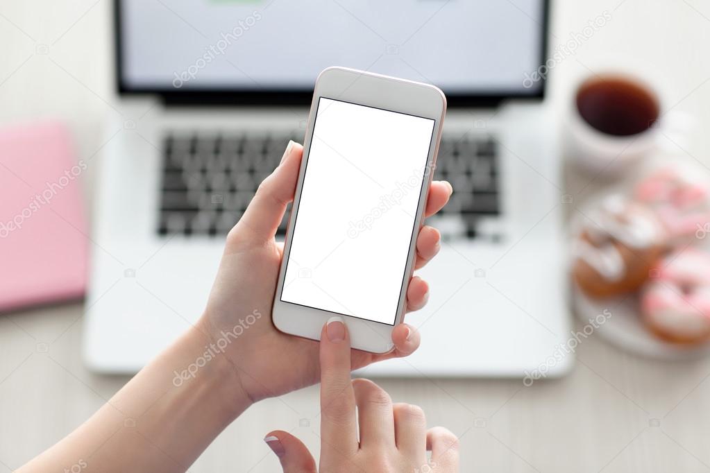 female hands holding phone with isolated screen and laptop