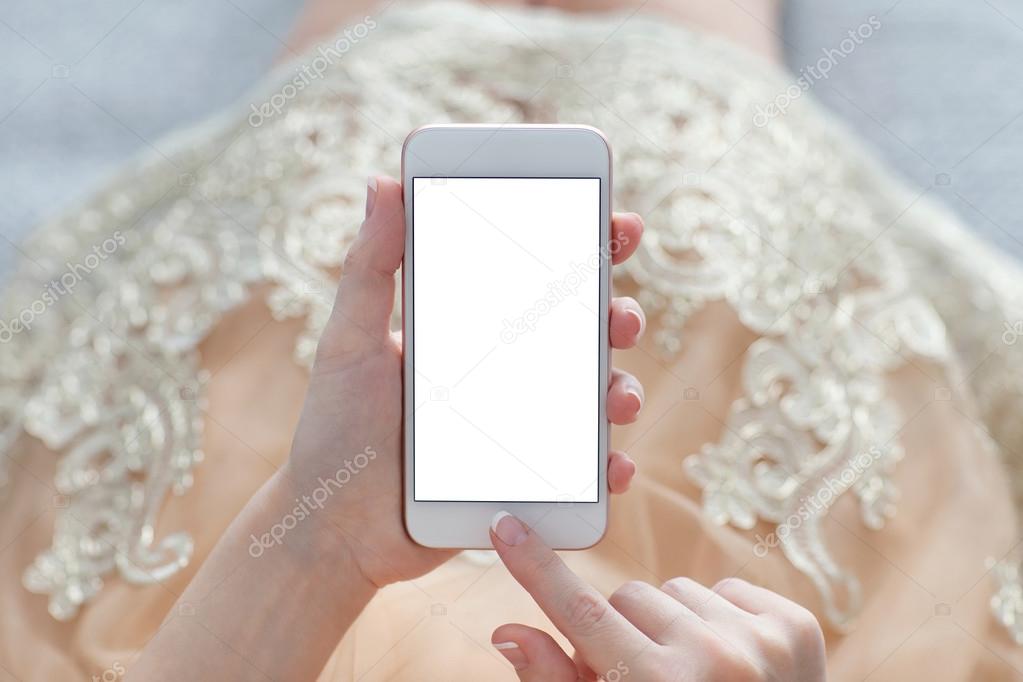 woman in a gold dress holding phone with isolated screen