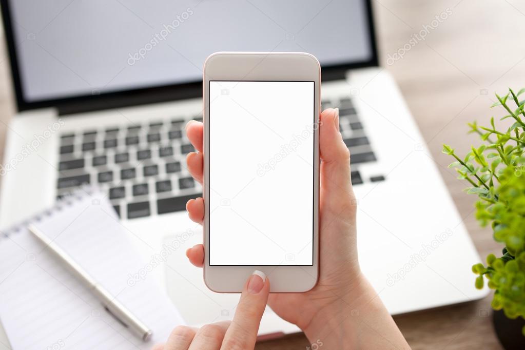 female hand holding phone with isolated screen and laptop