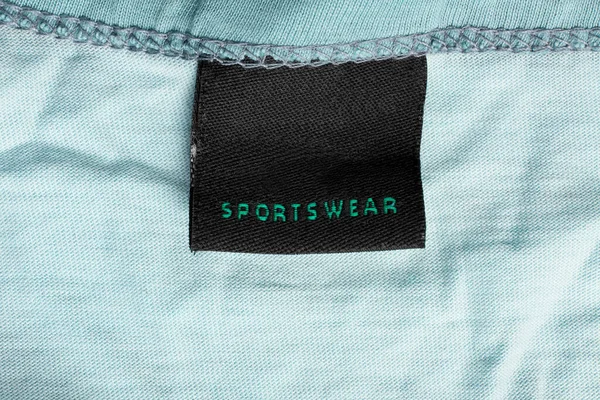 Etiqueta Ropa Dice Ropa Deportiva Sobre Fondo Textil Azul —  Fotos de Stock