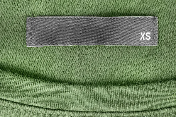 Розмір Етикетки Одягу Зеленому Язаному Фоні — стокове фото