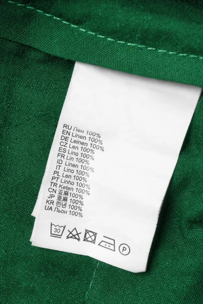 Ruházat Címkéjén 100 Vászon Van Különböző Nyelveken Zöld Textil Alapon Stock Kép