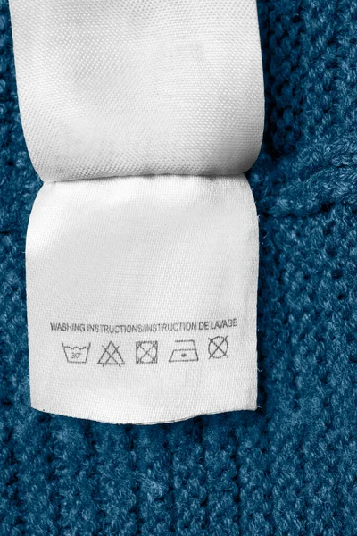 Instrucciones Lavado Etiqueta Ropa Sobre Fondo Punto Azul — Foto de Stock