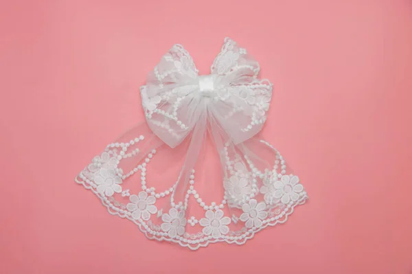 Beautiful hair bow for girls. Fashion accessory for girls hair on pink background.